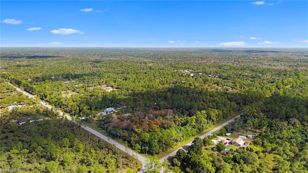 Aerial view of property's location featuring a forest