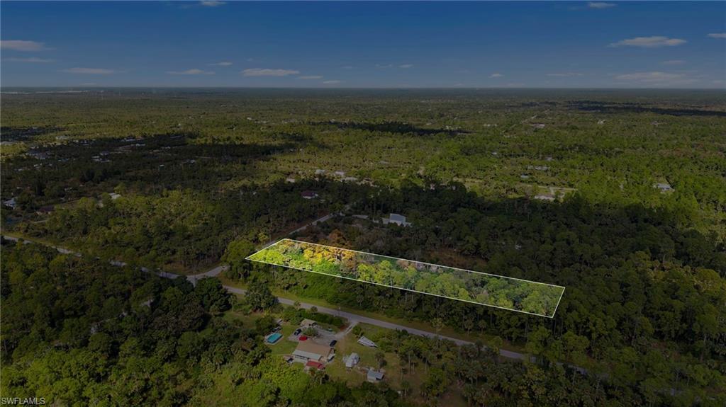 View of property location with a heavily wooded area and property parcel outlined