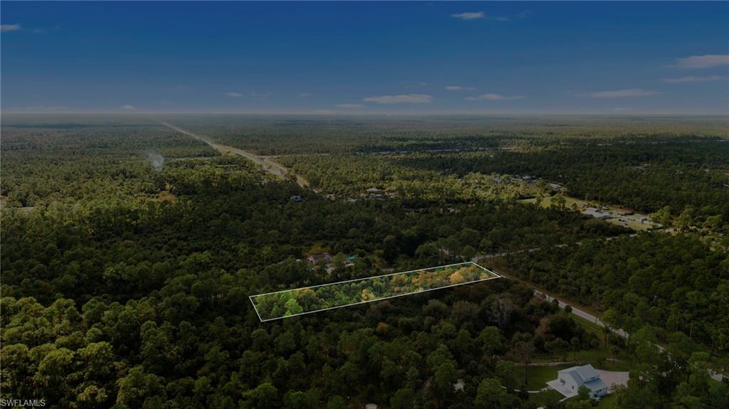 Aerial view of property's location featuring a heavily wooded area and property boundaries highlighted