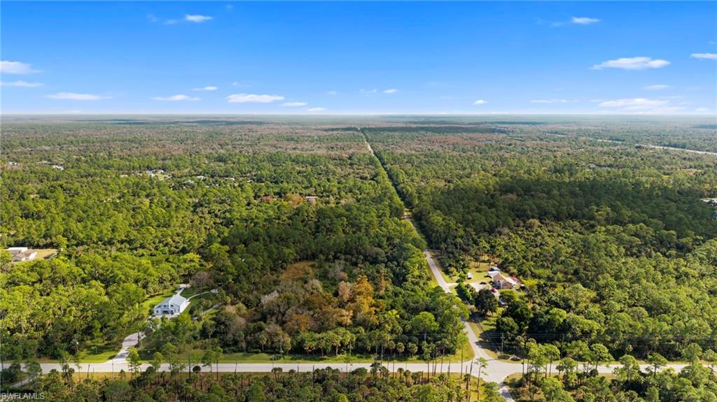 Aerial overview of property's location with a heavily wooded area