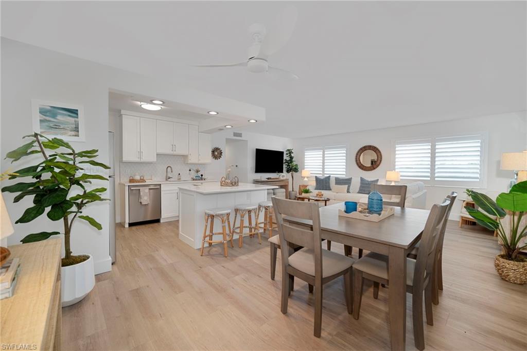 Dining area featuring light wood-type flooring, ceiling fan, and recessed lighting