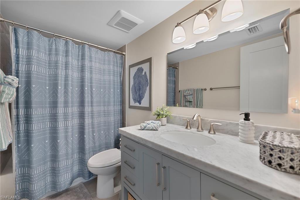 Full bathroom featuring vanity and shower / bath combination with curtain