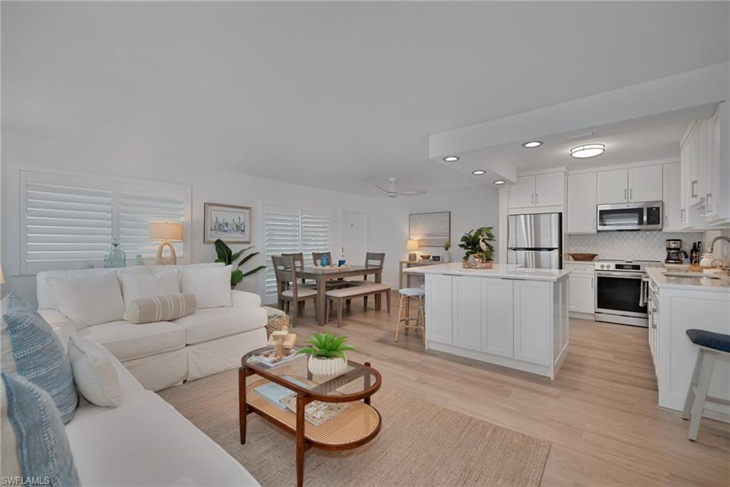 Living area with light wood finished floors, recessed lighting, and ceiling fan