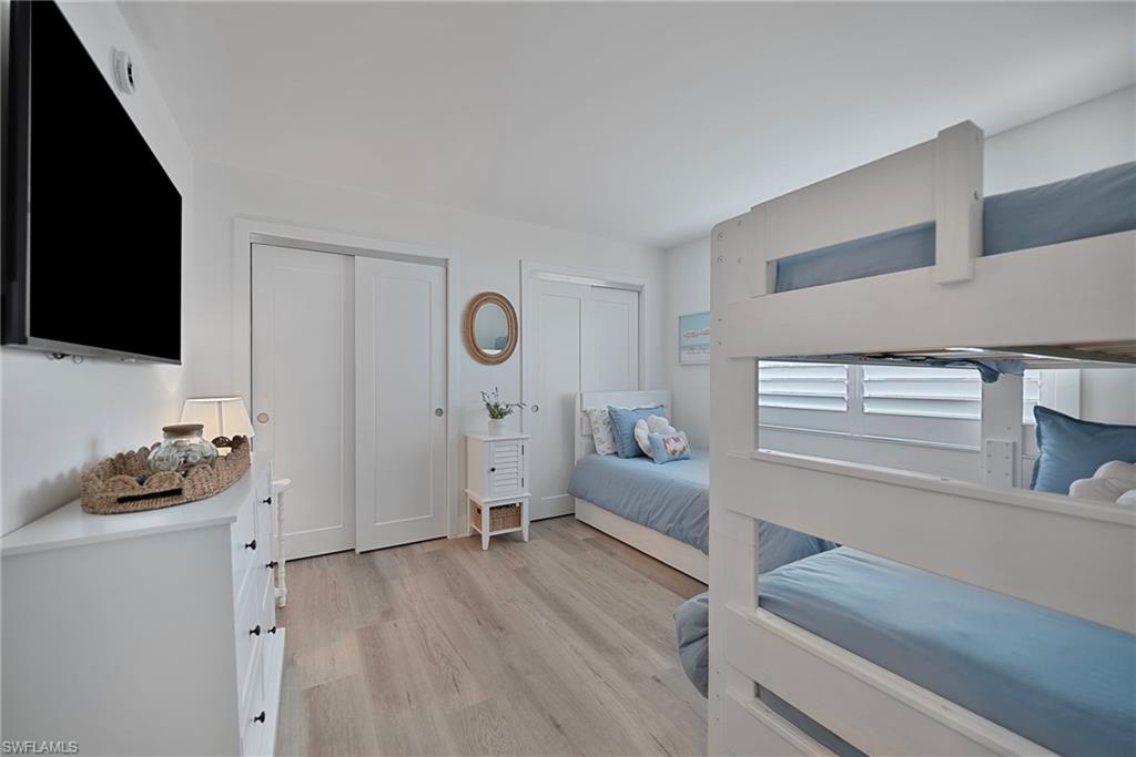 Bedroom with two closets and light wood-style floors