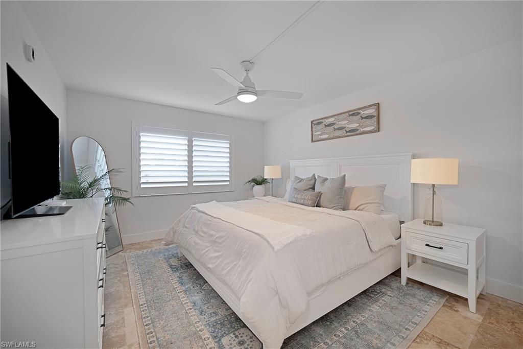 Bedroom with ceiling fan and baseboards
