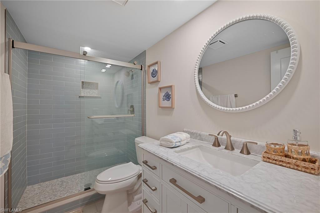 Bathroom featuring vanity, a shower stall, and tile patterned floors