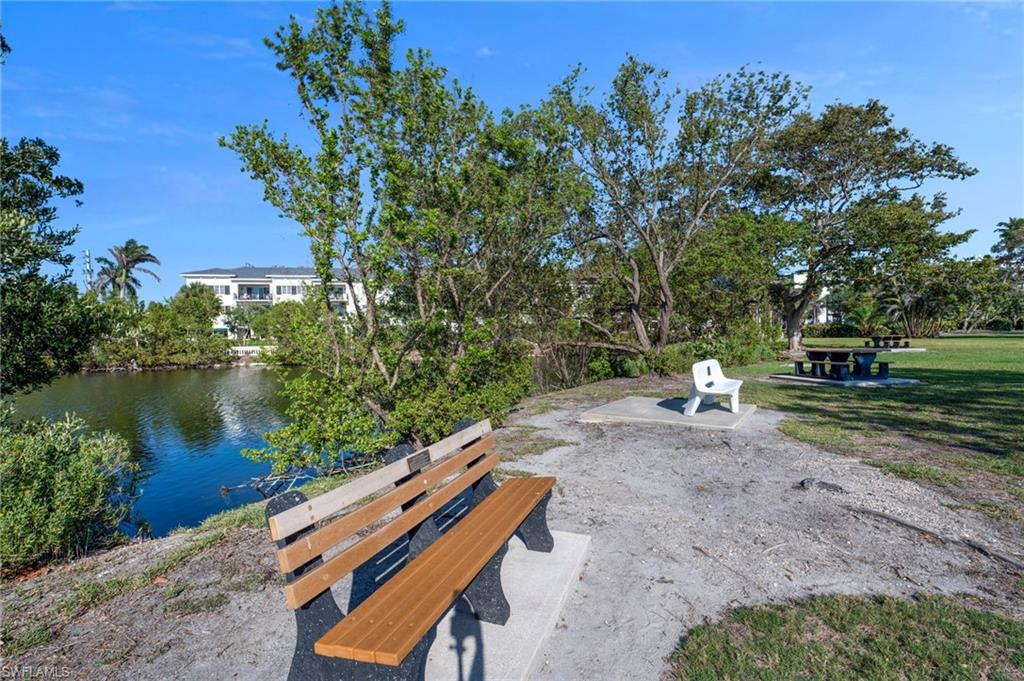 View of property's community featuring a water view and a patio area