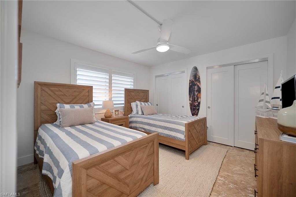 Bedroom with multiple closets and ceiling fan