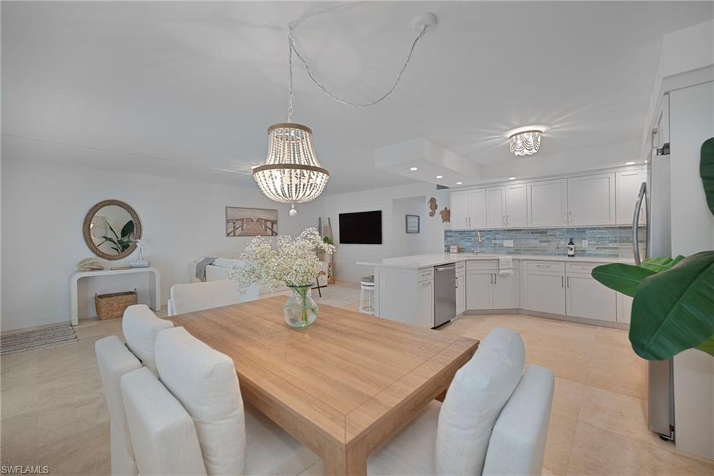 Dining area featuring recessed lighting, a chandelier, and light tile patterned flooring