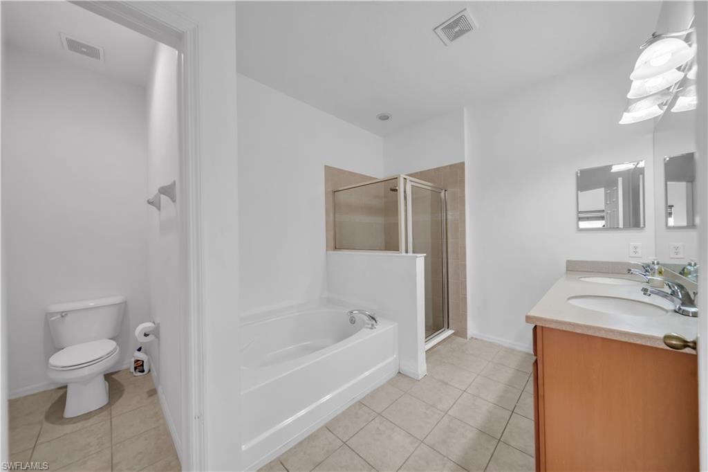 Bathroom with light tile patterned floors, a stall shower, and a garden tub