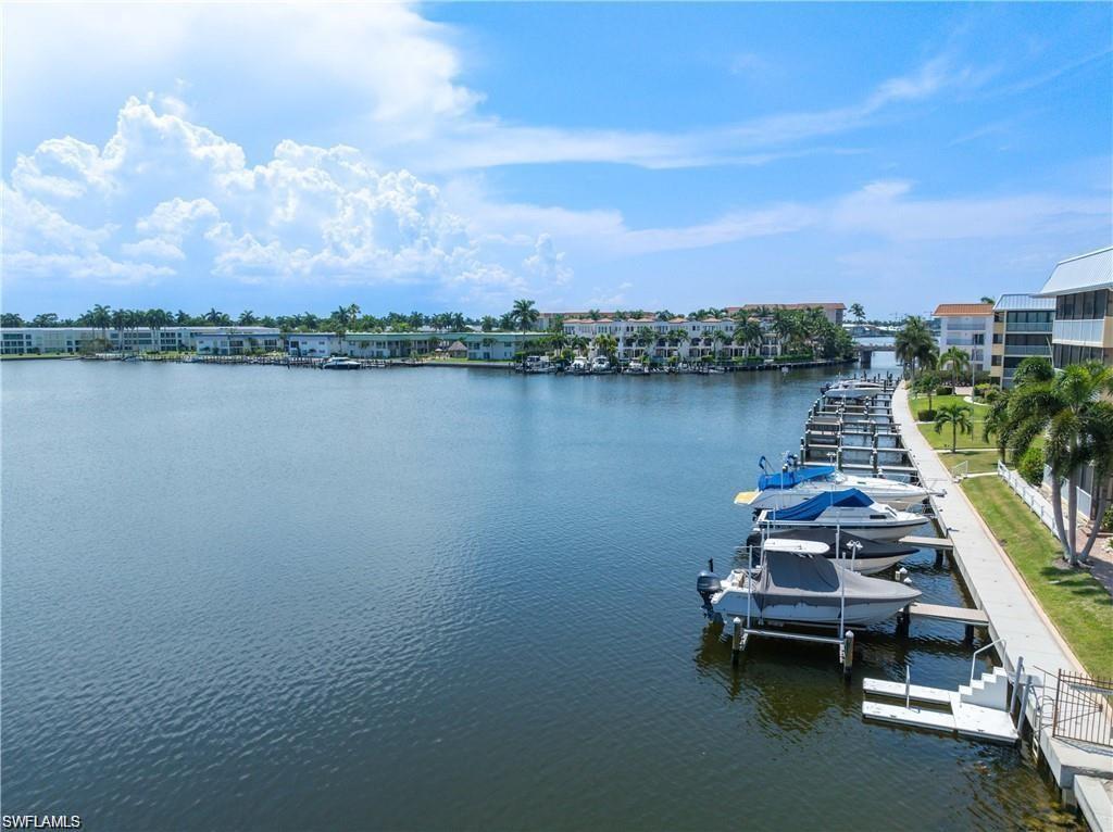 Water view with boat lift and a dock