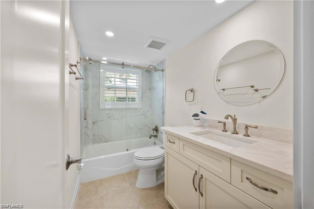 Full bathroom with shower / bath combination with glass door, vanity, recessed lighting, and light tile patterned flooring