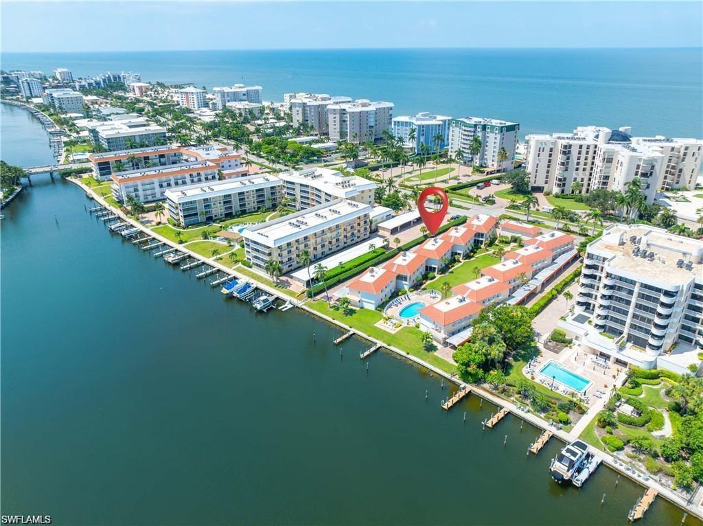 View of urban area with a nearby body of water and a pool