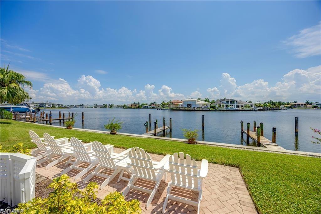 Dock with a water view and a lawn