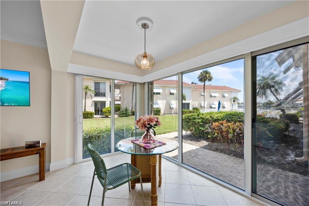 Doorway to outside with healthy amount of natural light and tile patterned flooring