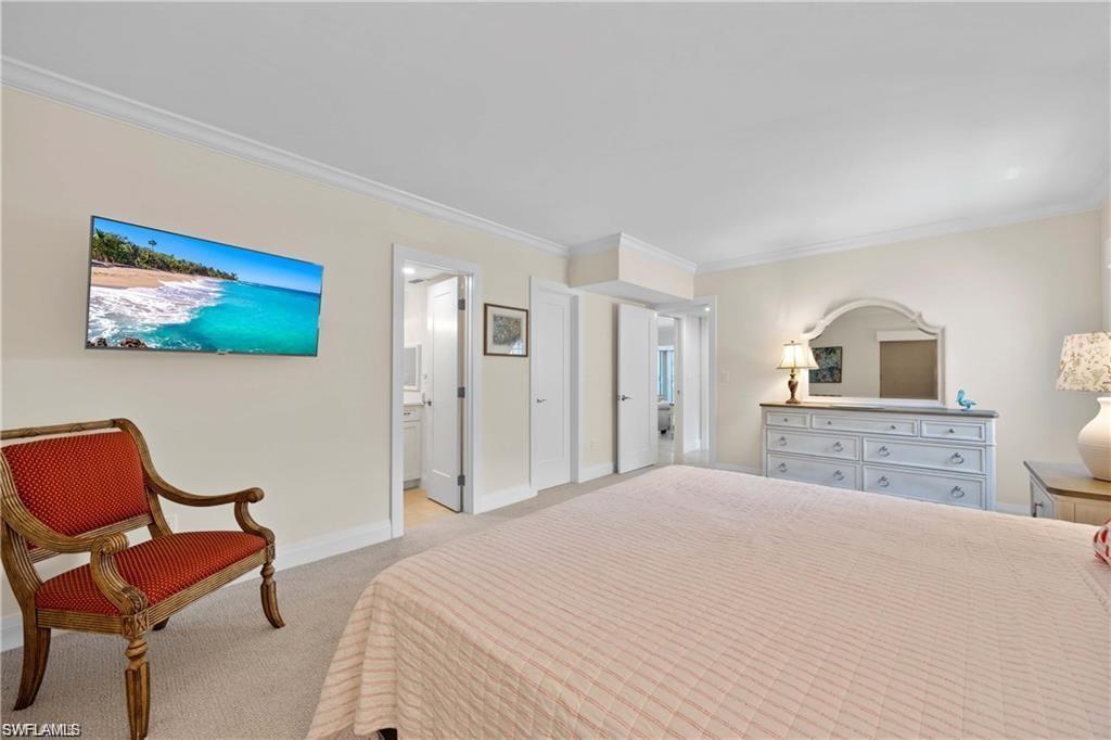 Bedroom featuring crown molding and light colored carpet