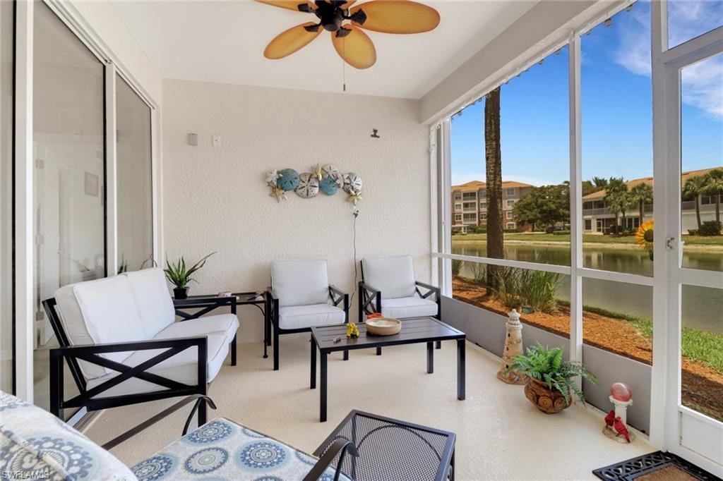 Sunroom / solarium with a water view, a ceiling fan, and outdoor lounge area