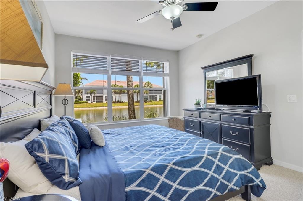 Carpeted bedroom featuring ceiling fan