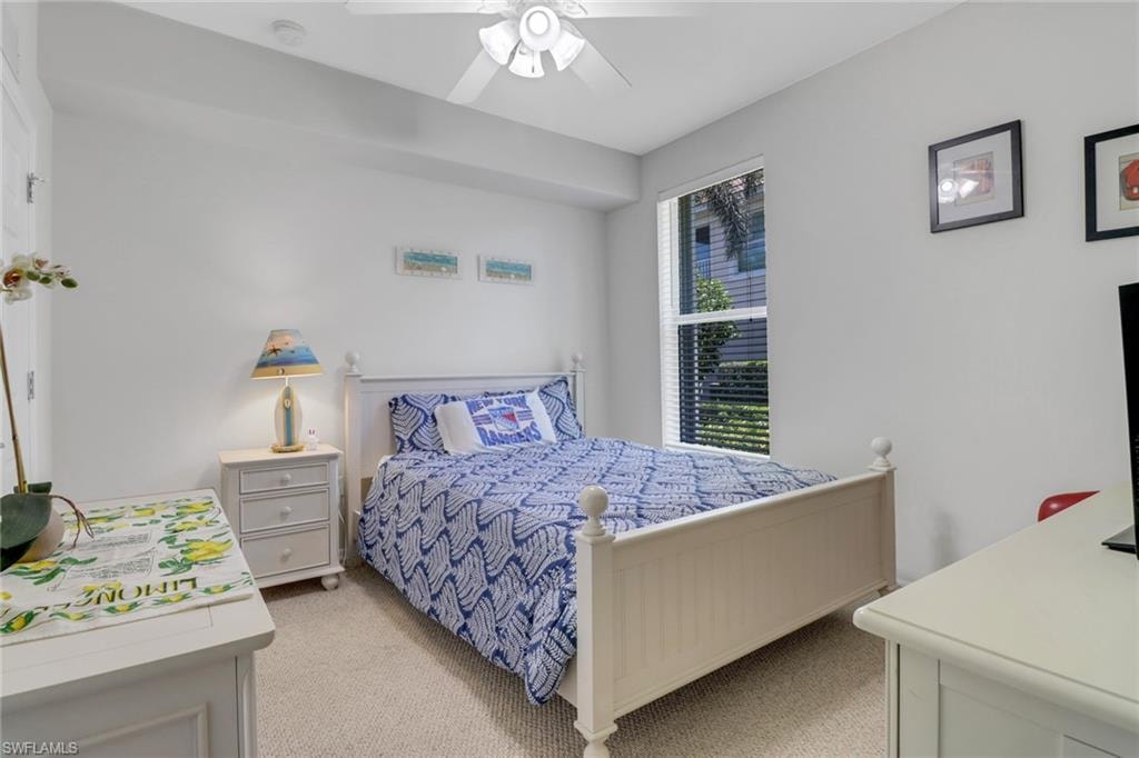 Bedroom featuring light colored carpet and ceiling fan