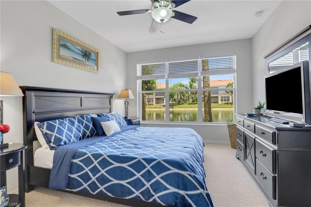 Bedroom featuring light colored carpet and a ceiling fan
