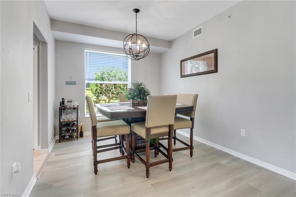 Dining space featuring light wood-style flooring and a chandelier