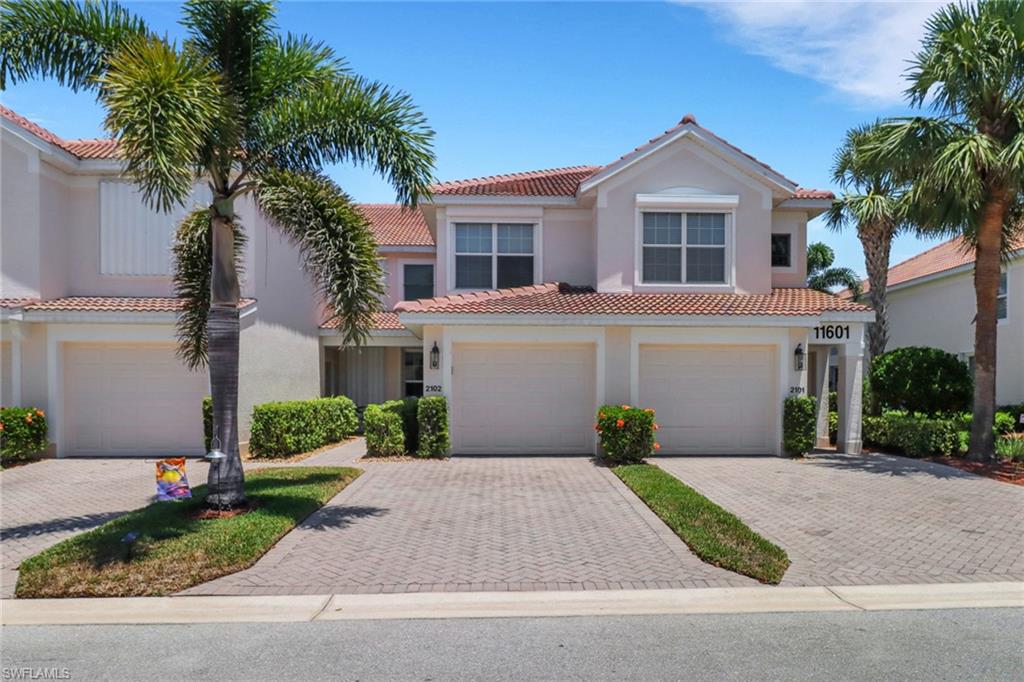 Mediterranean / spanish house featuring an attached garage, stucco siding, decorative driveway, and a tiled roof