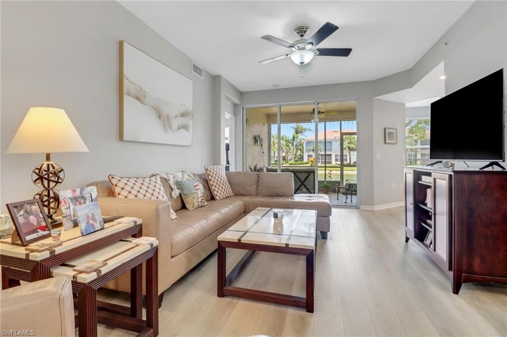 Living room with light wood-style floors and a ceiling fan