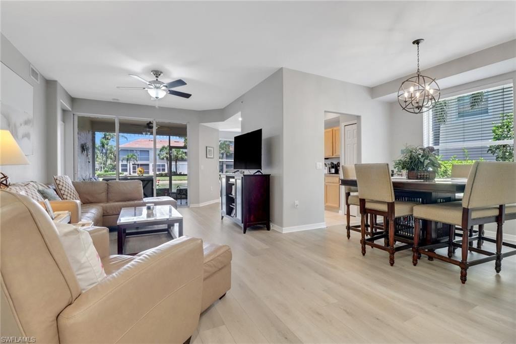 Living room featuring light wood-type flooring and a ceiling fan