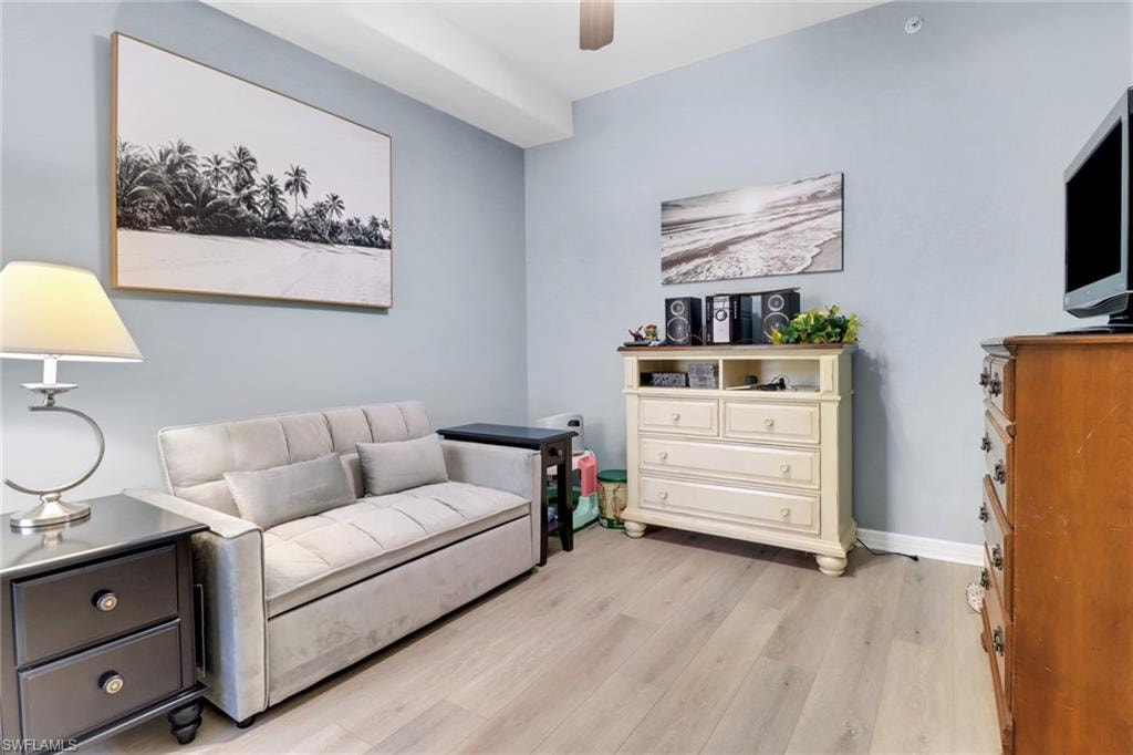 Living area featuring light wood finished floors and ceiling fan