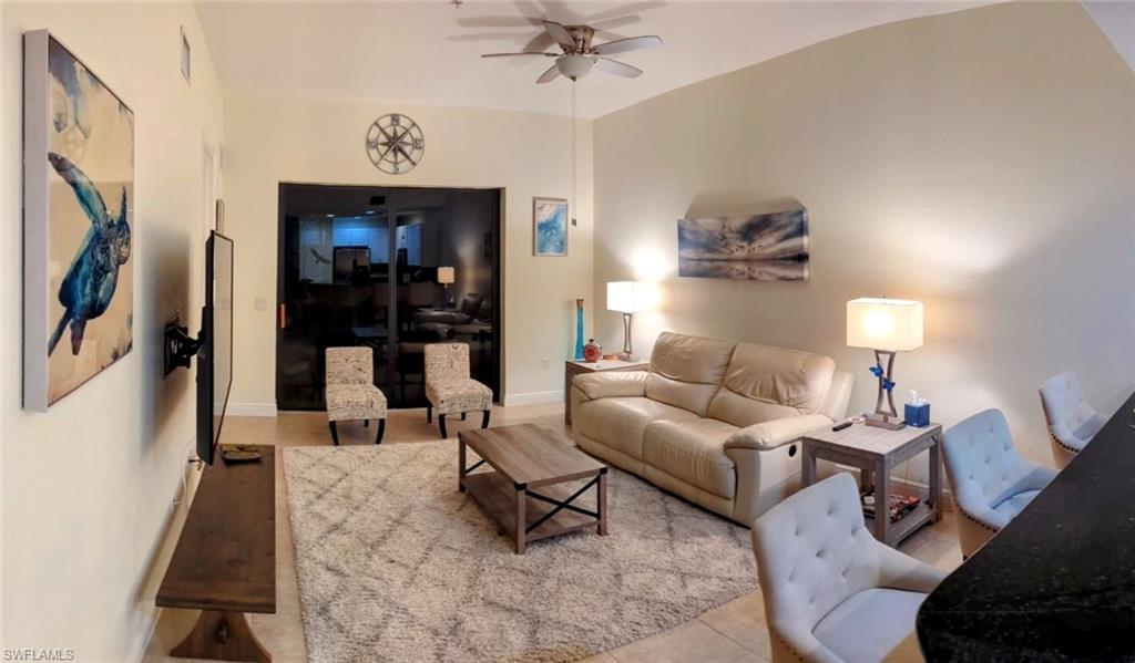 Living room with a ceiling fan and baseboards