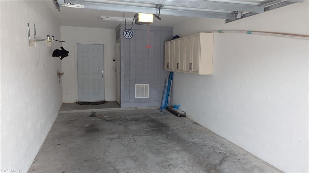 Garage featuring a garage door opener