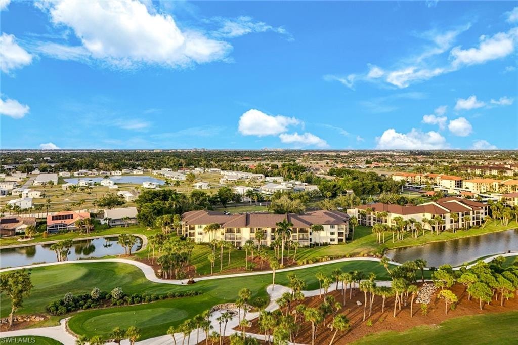 Drone / aerial view of a local golf course and a nearby body of water