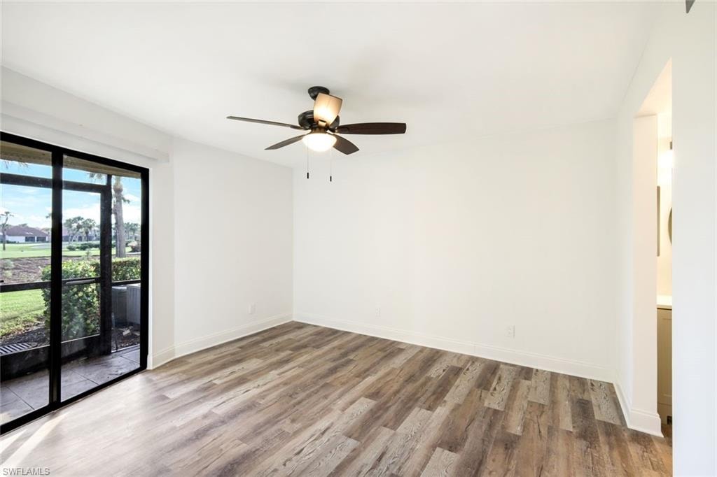 Empty room with light wood-style floors and a ceiling fan