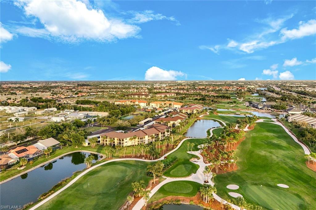 Aerial view of property's location with a nearby body of water, a golf club, and nearby suburban area