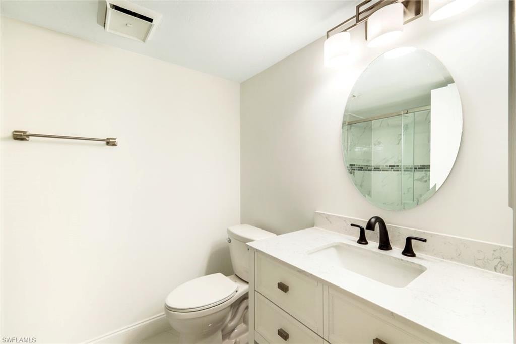 Full bathroom with vanity and a stall shower