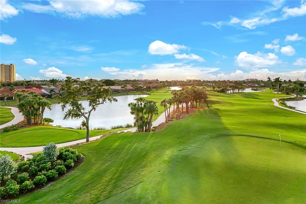 View of community with a water view, view of golf course, and a putting green