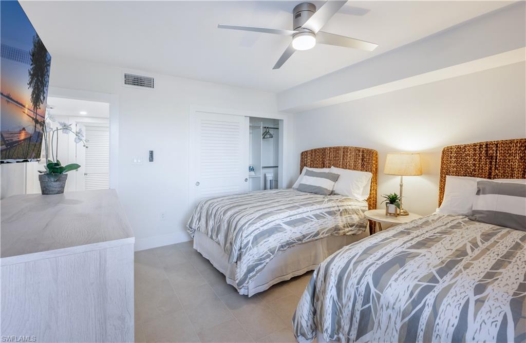 Two queen beds in guest bedroom plus TV