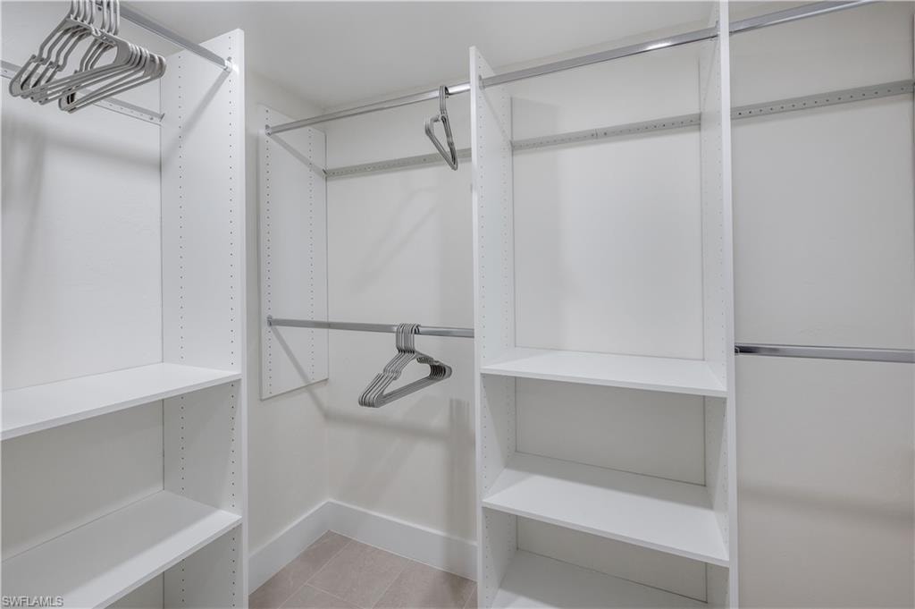 Large walk-in closet with wall mirror