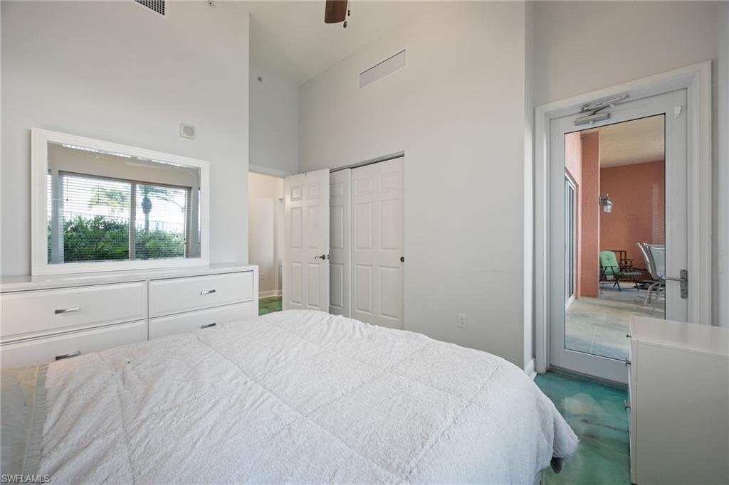 Bedroom featuring a high ceiling and a closet,