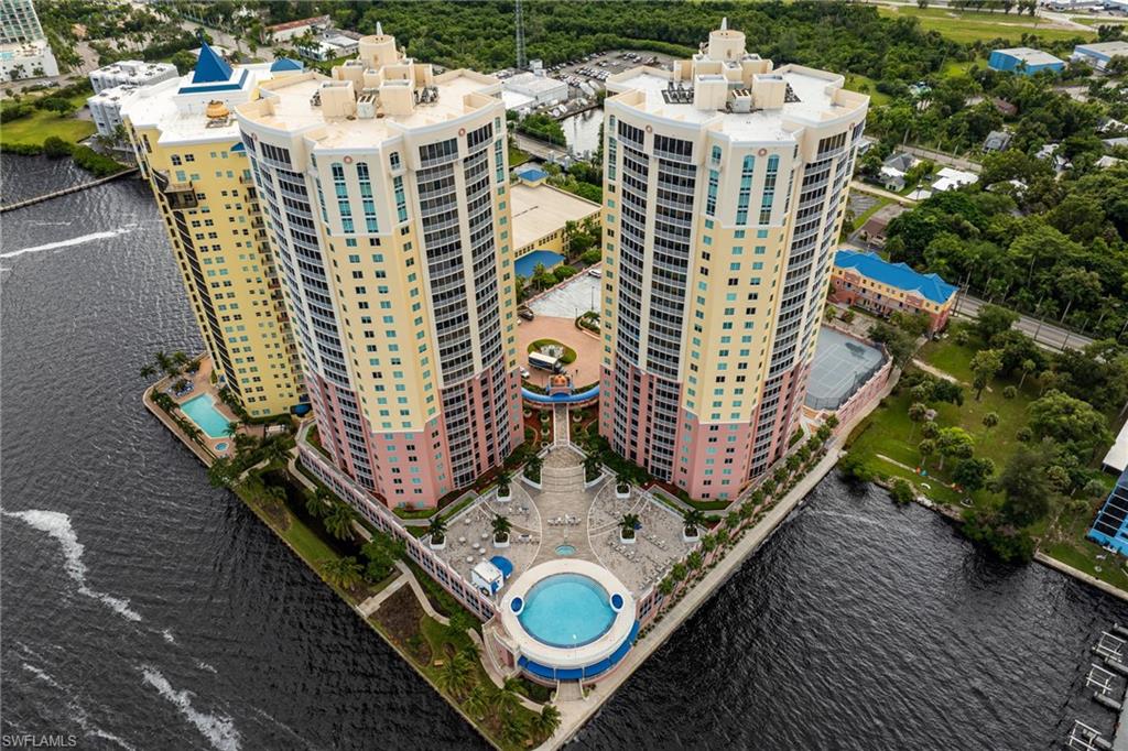 Bird's eye view of a nearby body of water and a pool area