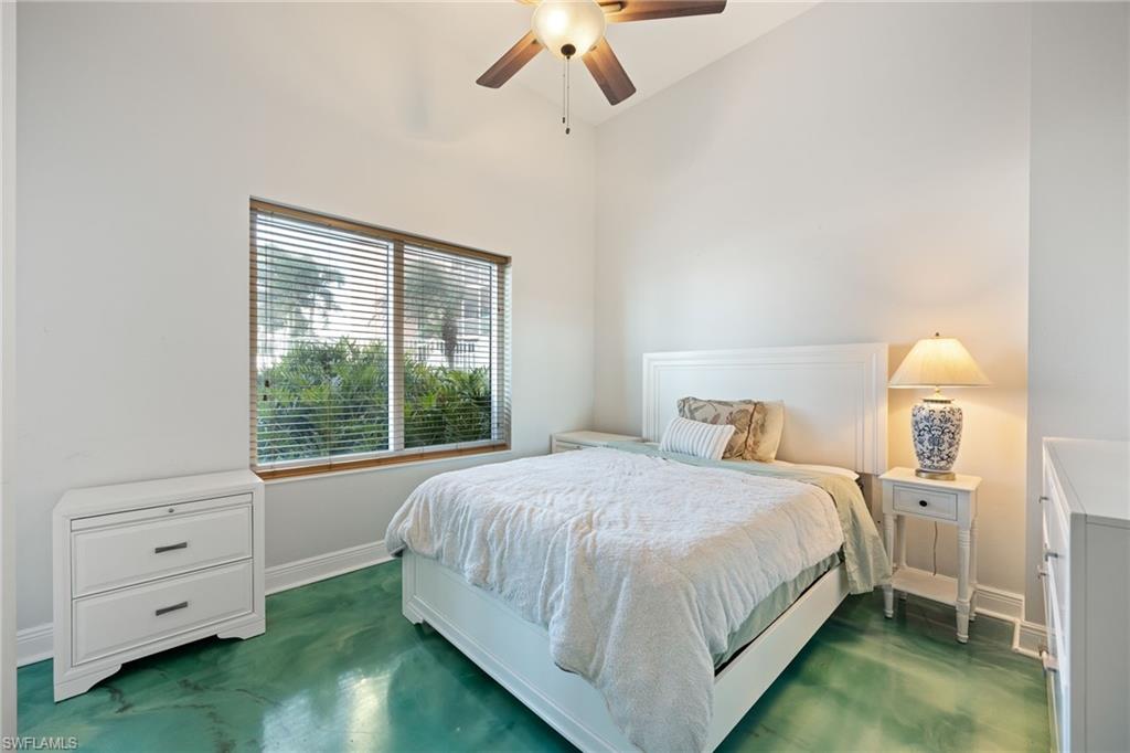Guest Bedroom featuring a ceiling fan, door to patio, and high vaulted ceiling