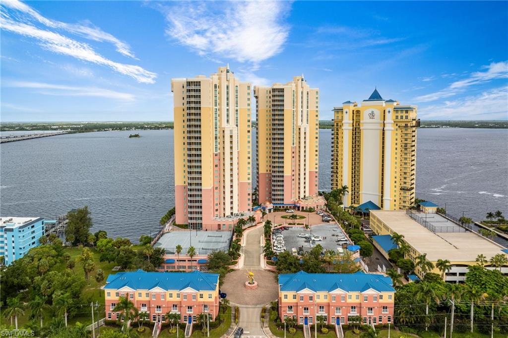 View of apartment building / complex featuring a water view