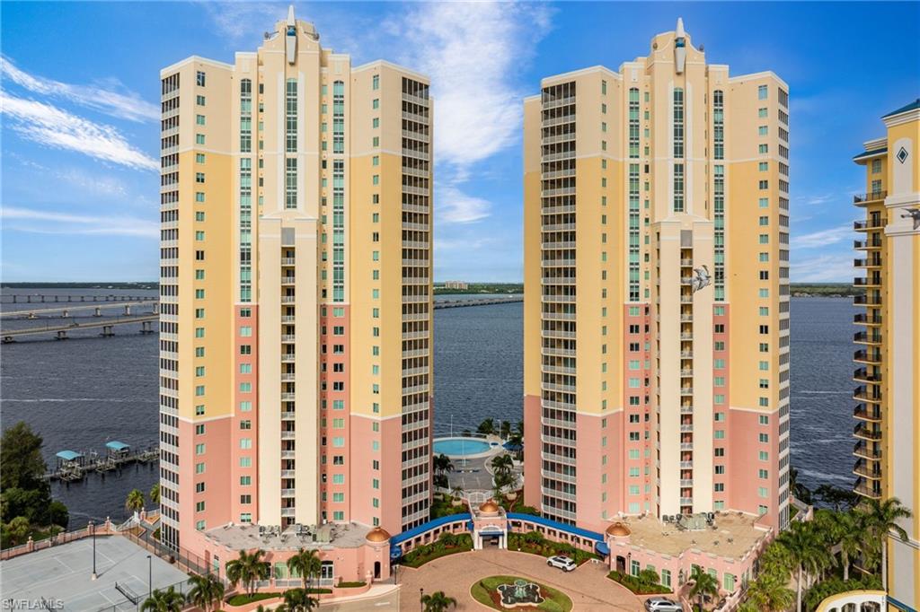 View of apartment building / complex featuring a water view