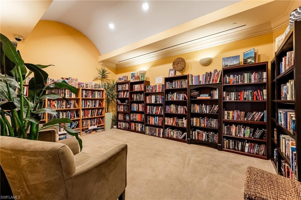Library community room featuring bookshelves, lofted ceiling, light colored carpet, and recessed lighting