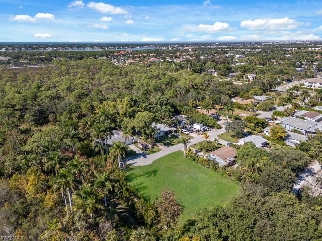 Aerial view of property and surrounding area with nearby suburban area