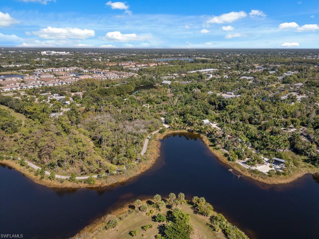 View of property location with a large body of water and a forest