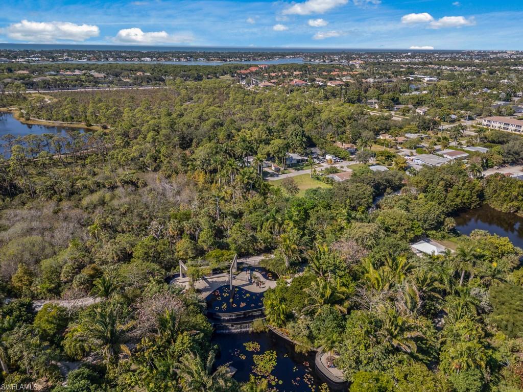 View of property location with a nearby body of water and a tree filled landscape