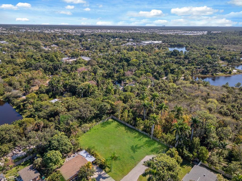 Aerial view of property and surrounding area featuring a nearby body of water