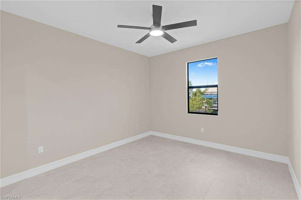 Empty room with baseboards and ceiling fan