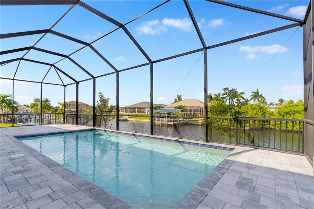Outdoor pool with a sunroom, a water view, a lanai, and a residential view